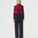 Wide black pants for women with elastic waistband. DV Bourgogne log sleeve turtleneck top for women.