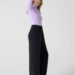 Wide black pants for women with elastic waist. DV. Lilac long sleeve turtleneck top.